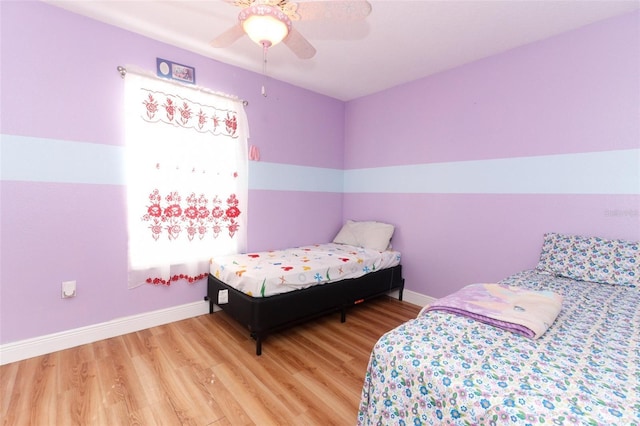 bedroom with hardwood / wood-style floors and ceiling fan