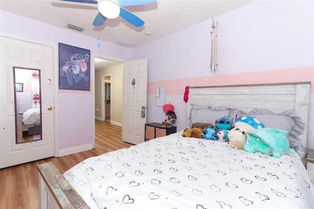 bedroom with ceiling fan and wood-type flooring