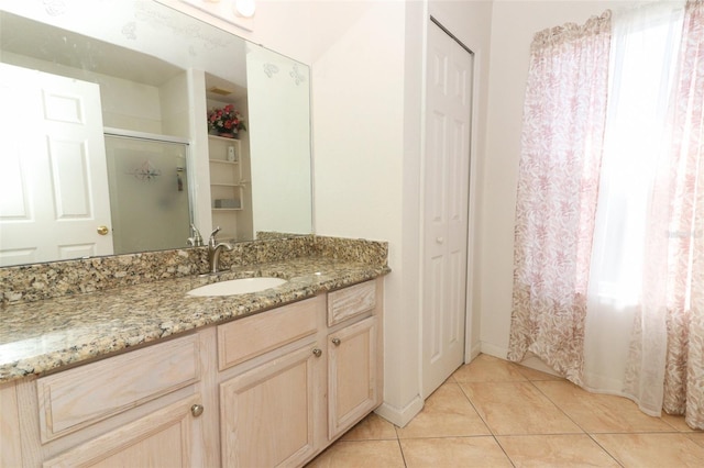 bathroom featuring a shower, tile patterned flooring, and vanity