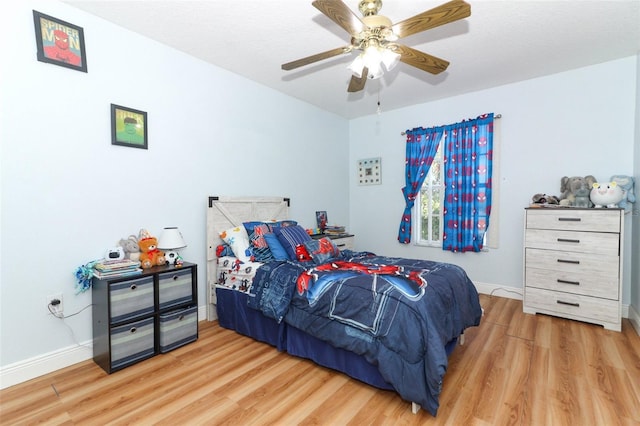 bedroom with ceiling fan and light hardwood / wood-style flooring