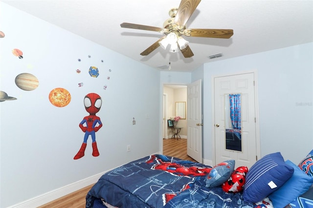 bedroom with hardwood / wood-style floors and ceiling fan