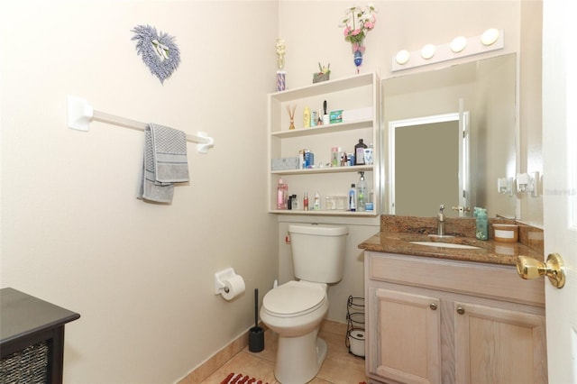 bathroom with tile patterned floors, vanity, and toilet