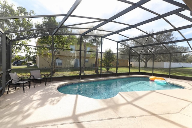 view of pool with a lanai, a yard, and a patio