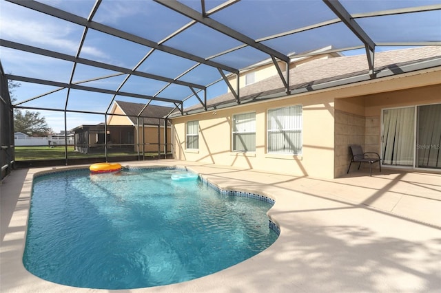 view of swimming pool featuring a patio and a lanai