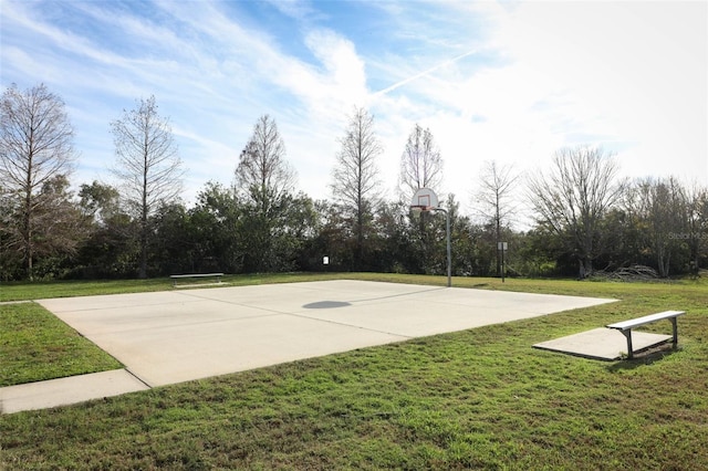 view of basketball court featuring a lawn