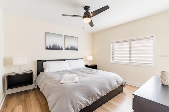 bedroom with ceiling fan and light hardwood / wood-style flooring