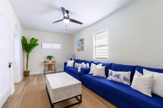 living room with ceiling fan and light wood-type flooring