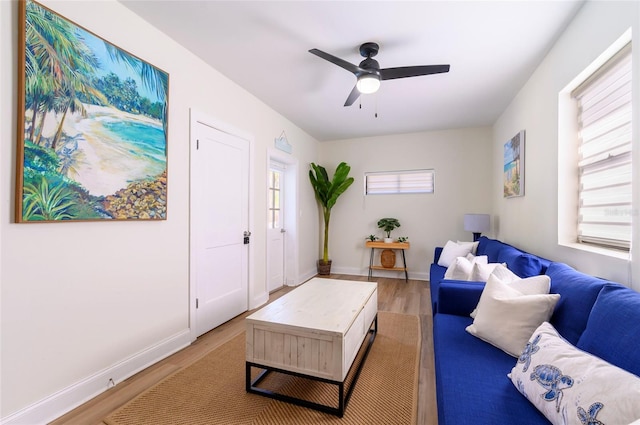 living room featuring wood-type flooring and ceiling fan