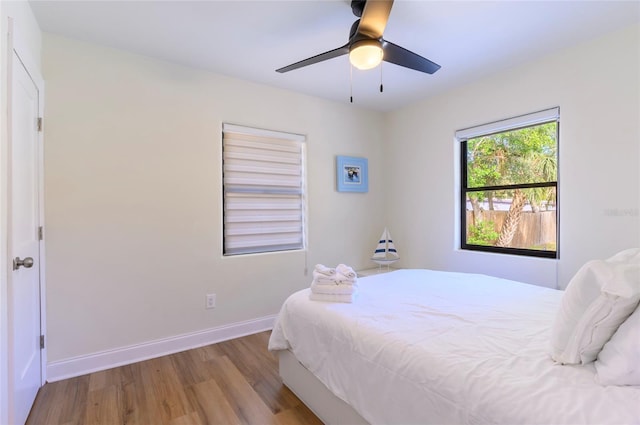 bedroom with light hardwood / wood-style floors and ceiling fan