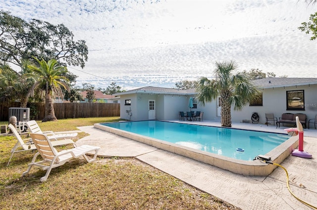 view of swimming pool with central AC unit and a patio area