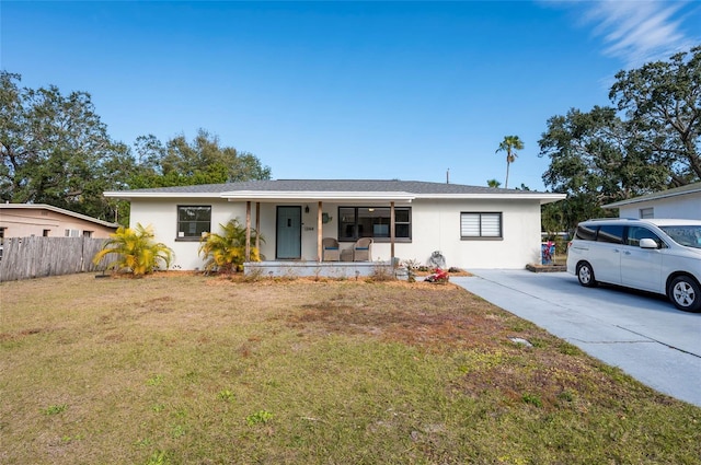 ranch-style home with a front yard and a porch