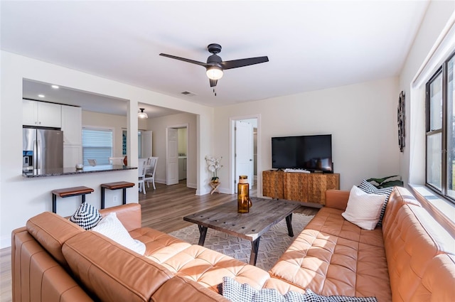 living room featuring ceiling fan and light wood-type flooring