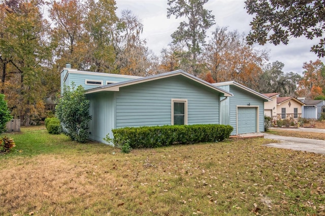 view of side of home with a lawn and a garage