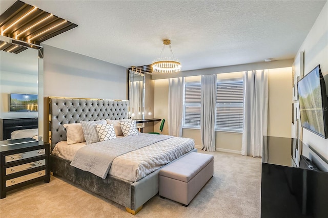 bedroom with a textured ceiling and light carpet