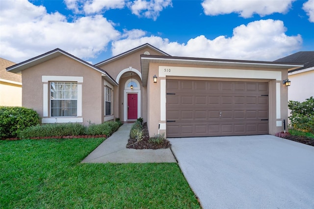 single story home featuring a garage and a front lawn