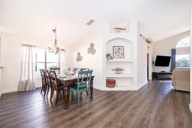 dining room with built in shelves, dark hardwood / wood-style flooring, a healthy amount of sunlight, and vaulted ceiling