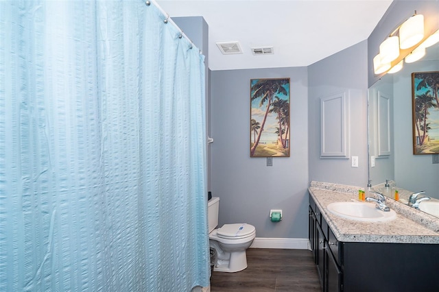 bathroom with hardwood / wood-style floors, vanity, and toilet