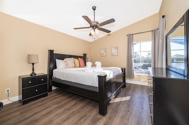 bedroom featuring ceiling fan, dark hardwood / wood-style flooring, and lofted ceiling