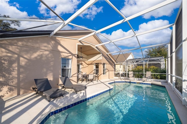 view of swimming pool featuring a lanai and a patio