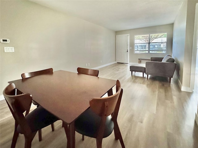 dining space with light hardwood / wood-style flooring