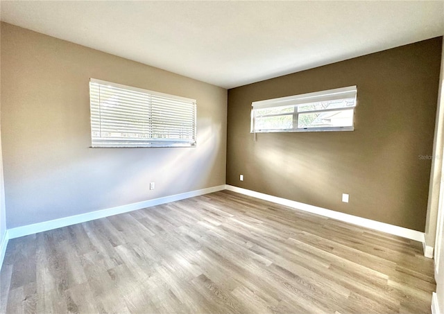 spare room featuring light wood-type flooring