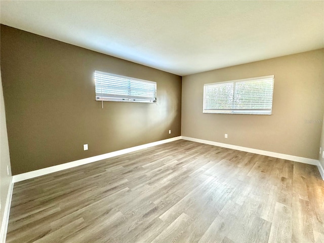 empty room with light hardwood / wood-style floors