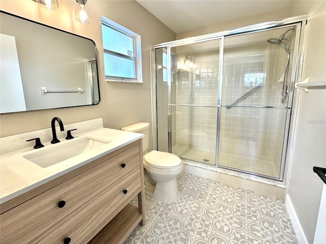 bathroom featuring tile patterned floors, vanity, an enclosed shower, and toilet