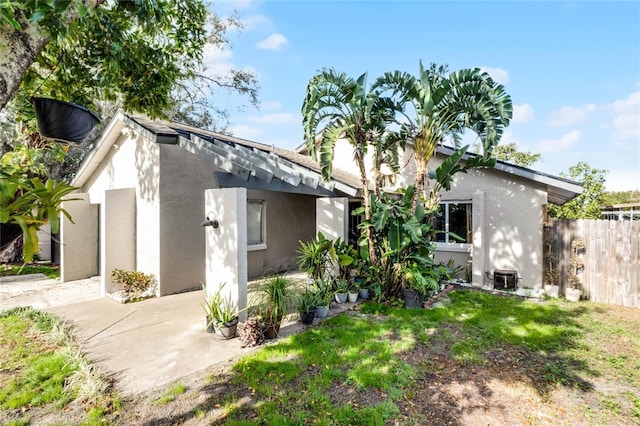 view of side of home with a yard