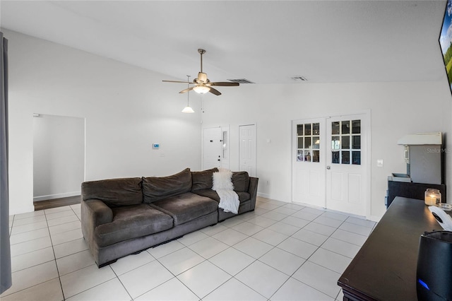 tiled living room featuring ceiling fan, lofted ceiling, and french doors