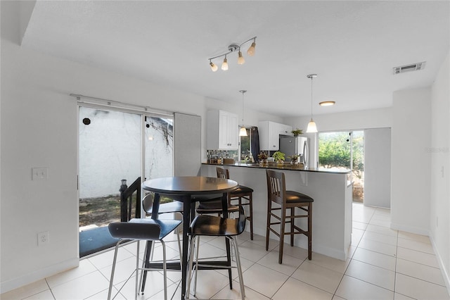 dining area featuring light tile patterned floors