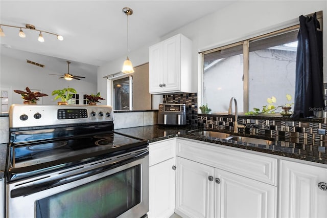 kitchen with stainless steel range with electric stovetop, ceiling fan, sink, white cabinets, and hanging light fixtures