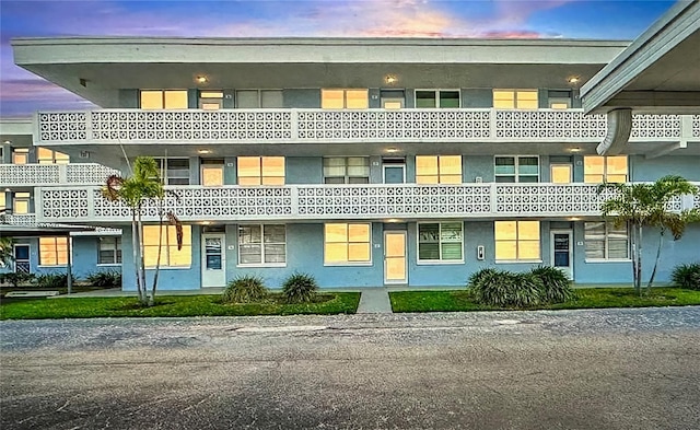 view of outdoor building at dusk