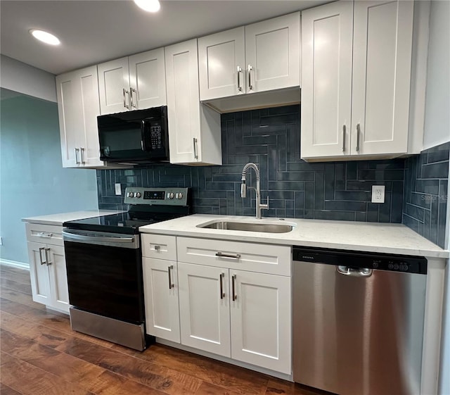 kitchen with dark hardwood / wood-style flooring, tasteful backsplash, stainless steel appliances, sink, and white cabinets