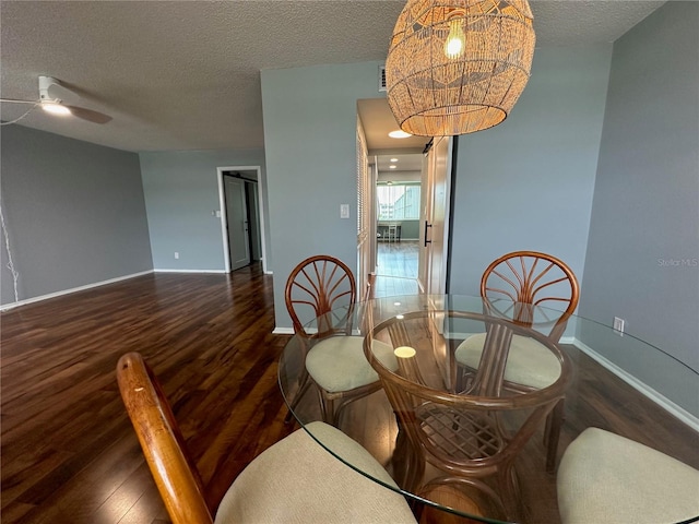 dining room featuring a textured ceiling, dark hardwood / wood-style floors, and ceiling fan