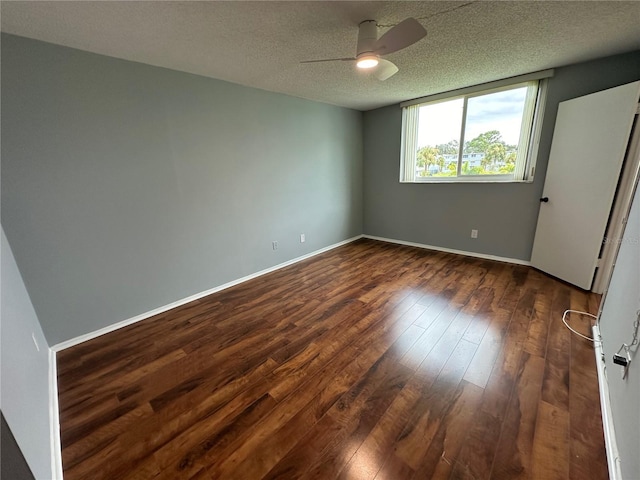 unfurnished bedroom featuring ceiling fan, dark wood-type flooring, and a textured ceiling