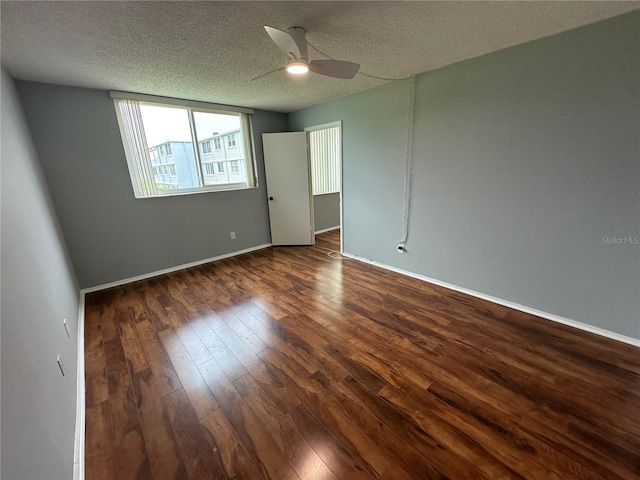 unfurnished room featuring ceiling fan, dark hardwood / wood-style flooring, and a textured ceiling