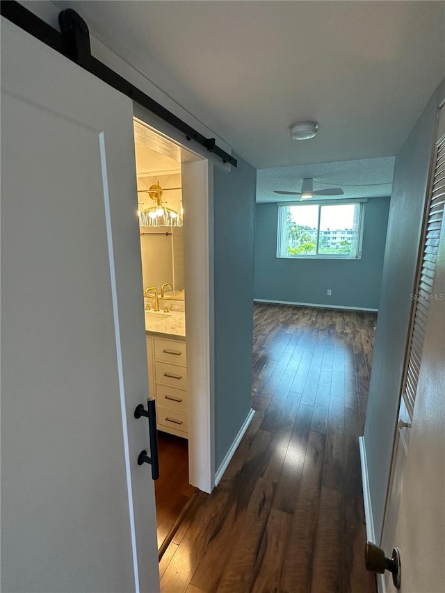 hallway with dark hardwood / wood-style flooring and sink