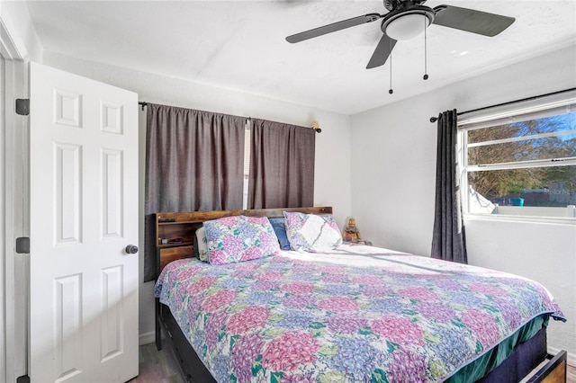 bedroom with hardwood / wood-style flooring and ceiling fan