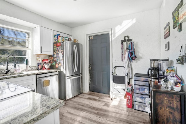 kitchen with sink, white cabinets, and stainless steel appliances