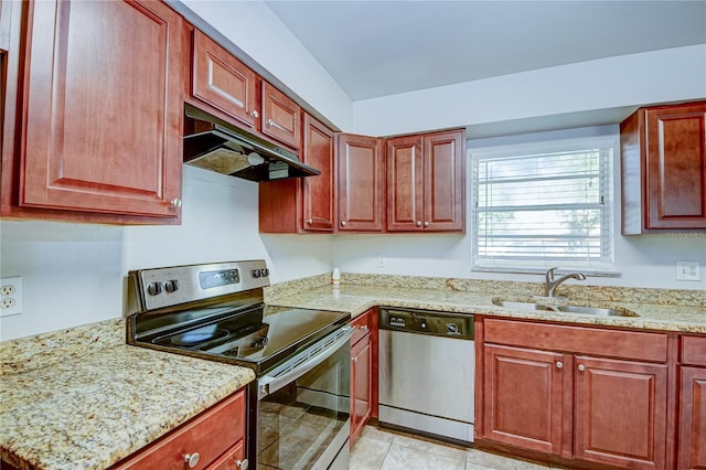 kitchen with sink, stainless steel appliances, light tile patterned floors, and light stone countertops