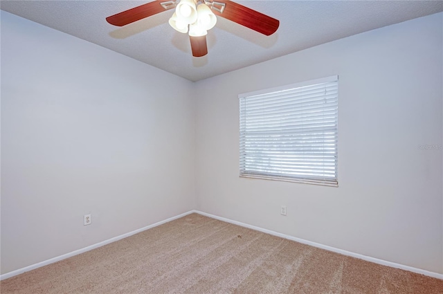 carpeted empty room with a textured ceiling and ceiling fan