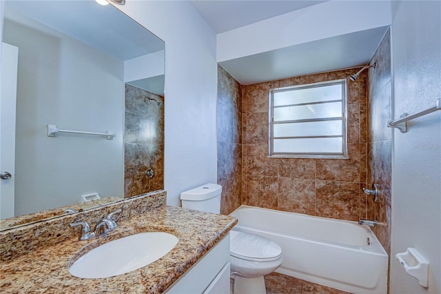 full bathroom with vanity, toilet, tiled shower / bath, and tile patterned floors