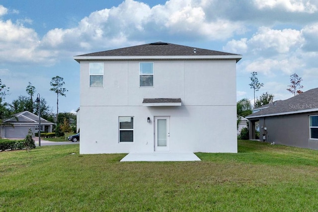 back of house with a yard and a patio