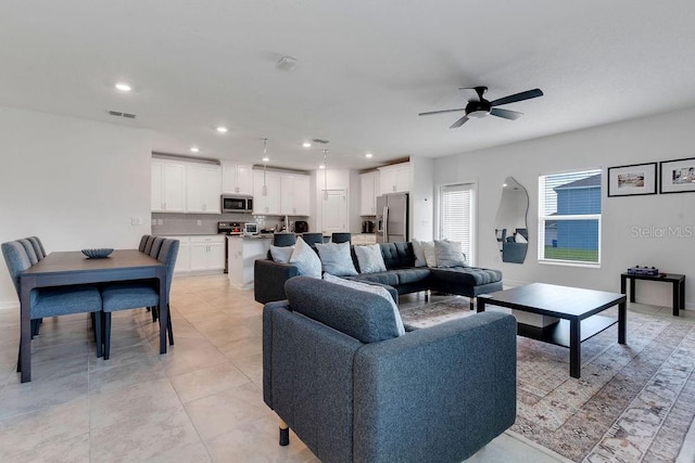 living room with ceiling fan and light tile patterned floors