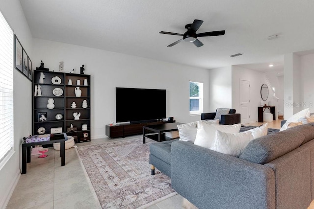 tiled living room featuring a wealth of natural light and ceiling fan