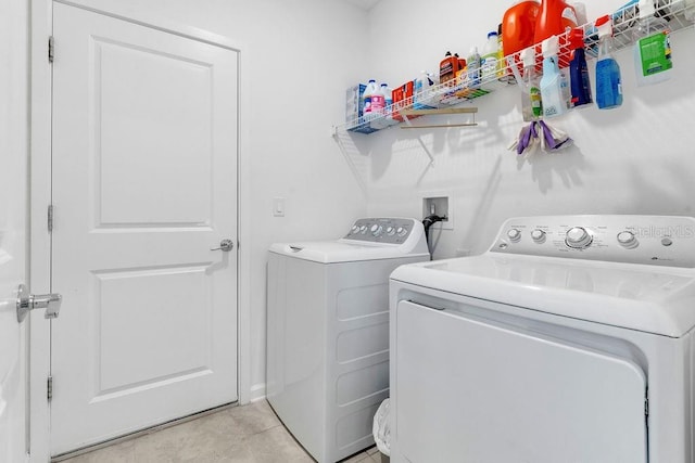 laundry room featuring washer and dryer and light tile patterned floors