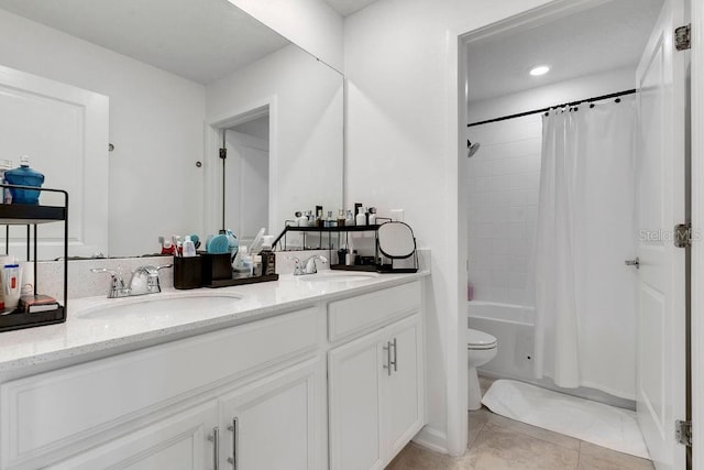 full bathroom featuring toilet, shower / bath combination with curtain, vanity, and tile patterned floors