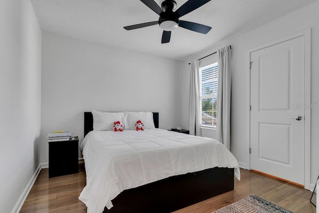 bedroom featuring ceiling fan and hardwood / wood-style flooring