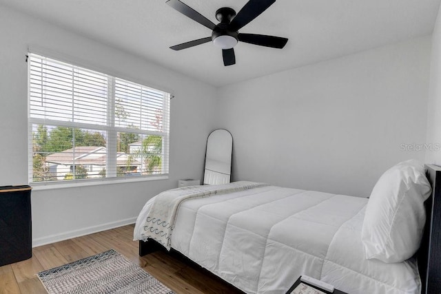 bedroom with ceiling fan and hardwood / wood-style floors