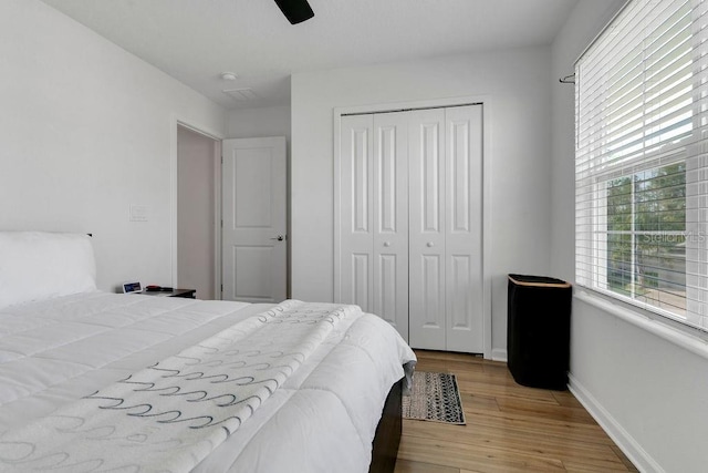 bedroom featuring light hardwood / wood-style floors, a closet, and ceiling fan